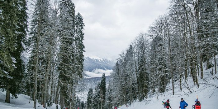 trois skieurs sur une piste de ski